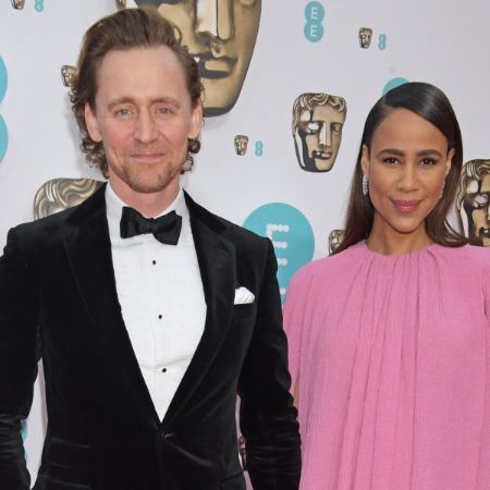 Tom Hiddleston in a black suit along with his fiancée, Zawe Ashton
